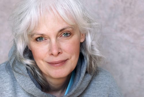 portrait of happy mature woman with natural white hair and minimal makeup-img-blog